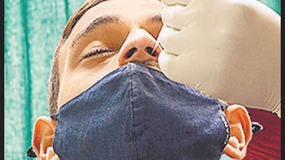 Amritsar: A healthworker collects a nasal swab sample for COVID-19 test at a hospital in Amritsar, Tuesday, Jan. 18, 2022. (PTI Photo)(PTI01_18_2022_000092A) (PTI) Amritsar: A healthworker collects a nasal swab sample for COVID-19 test at a hospital in Amritsar, Tuesday, Jan. 18, 2022. (PTI Photo)(PTI01_18_2022_000092A) (PTI)