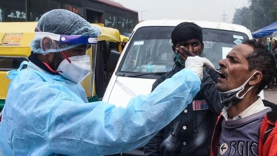 A health worker collects a swab sample from a person for coronavirus (Covid-19) test, at Jangpura in New Delhi. A health worker collects a swab sample from a person for coronavirus (Covid-19) test, at Jangpura in New Delhi. 
