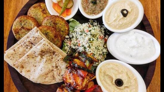 Mediterranean mezze platter with home-made hummus, air-fried falafel, tofu balls, baba ganoush and whole wheat pita bread