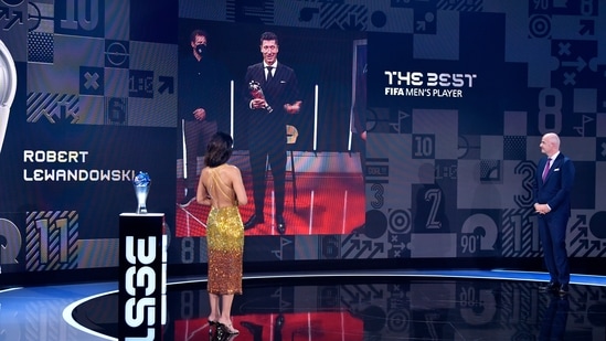 FIFA President Gianni Infantino speaks with the Best FIFA Men's Player 2021 award winner Robert Lewandowski during the Best FIFA Football Awards 2021 in Zurich, Switzerland(AP)