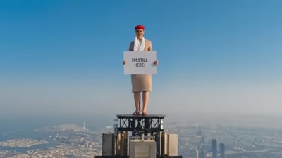 The image, taken from the Emirates ad video posted on YouTube, shows the woman standing atop Burj Khalifa. (YouTube/@Emirates)