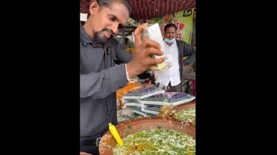 A man at a Nagpur eatery, grating some cheese into the flavoured water of the paani puri. (instagram/@food_o_logy_nagpur) A man at a Nagpur eatery, grating some cheese into the flavoured water of the paani puri. (instagram/@food_o_logy_nagpur)