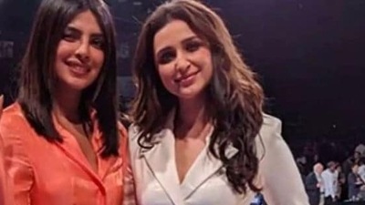 Parineeti Chopra and Priyanka Chopra pose together.