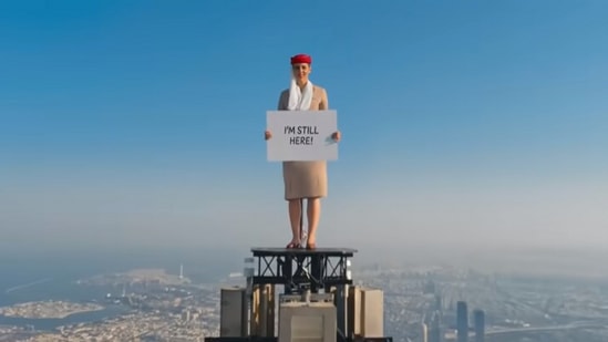 The image, taken from the Emirates ad video posted on YouTube, shows the woman standing atop Burj Khalifa.(YouTube/@Emirates)