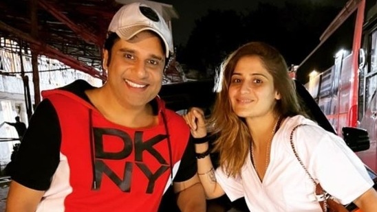 Krushna Abhishek and Arti Singh pose together with his new car.&nbsp;