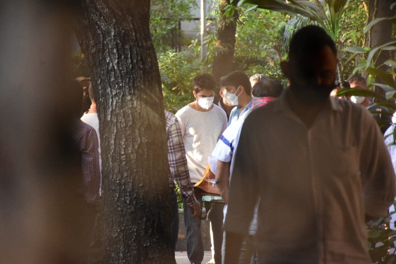 Rohit and Varun talking at the funeral.