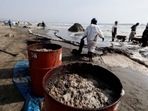 Workers clean an oil spill caused by abnormal waves, triggered by a massive underwater volcanic eruption in Tonga, off the coast of Lima, in Ventanilla, Peru.(REUTERS)