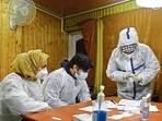 Healthcare workers process Covid-19 test at a government department in Srinagar.(PTI File Photo) Healthcare workers process Covid-19 test at a government department in Srinagar.(PTI File Photo)