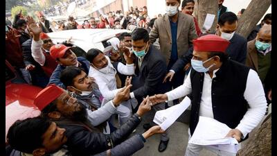 Samajwadi Party [resident Akhilesh Yadav meets party workers after a press conference at the party office, in Lucknow. on Thursday. (ANI Photo)
