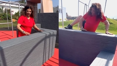Pinkie Roshan climbing up a high barrier. Pinkie Roshan climbing up a high barrier.