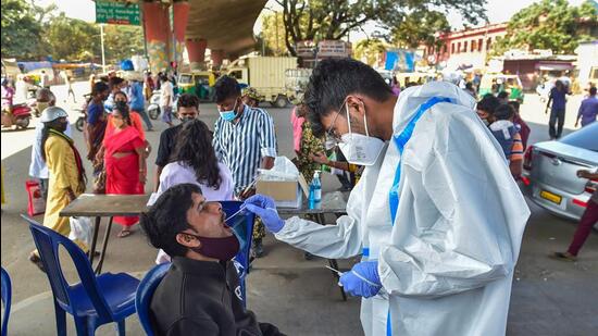 A health worker collects asample for Covid-19 testing in Bengaluru on Thursday (PTI) A health worker collects asample for Covid-19 testing in Bengaluru on Thursday (PTI)
