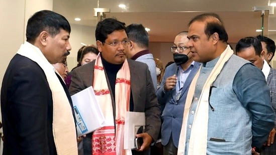 Assam chief minister Himanta Biswa Sarma interacts with Meghalaya chief minister Conrad Sangma in Guwahati.(ANI)