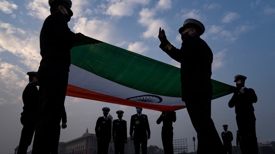 Indian soldiers prepare to fold the Indian national flag during rehearsals for the upcoming Beating Retreat ceremony.(AP)