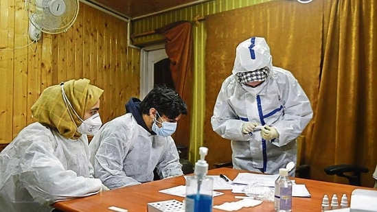 Healthcare workers process Covid-19 test at a government department in Srinagar.(PTI File Photo)