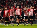 Athletic Bilbao's Dani Garcia celebrates after the match with teammates.