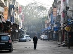 A man walking in the midst of a deserted Sarojini Nagar market during a weekend curfew in New Delhi on Sunday. (ANI Photo) A man walking in the midst of a deserted Sarojini Nagar market during a weekend curfew in New Delhi on Sunday. (ANI Photo)