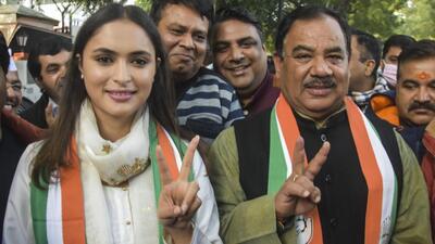 Former BJP leader Harak Singh Rawat and his daughter in law Anukriti flash victory sign after joining Congress, in New Delhi, ahead of the Uttarakhand elections, on Friday. (PTI)