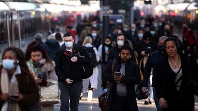 People walk along a platform at King's Cross train station amid the ongoing coronavirus disease (Covid-19) outbreak in London, Britain.&nbsp; (REUTERS)