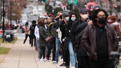 Queue at a testing site to receive a free Covid-19 PCR test in Farragut Square in Washington, DC. (AFP)
