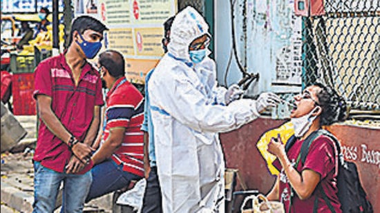 A health worker collects swab sample for Covid-19 test in Bengaluru. (PTI )