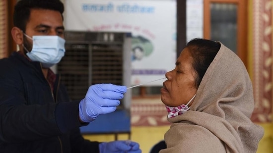 A health worker takes a person’s swab sample for RT-PCR Covid-19 testing at an UPHC in Wazirabad, in Gurugram. (Photo by Vipin Kumar / Hindustan Times)