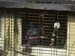 Fire brigade personnel carry out cooling operation after a blaze gutted a flat in Kamala building at Tardeo in Mumbai on Saturday.(Anshuman Poyrekar/HT Photo) Fire brigade personnel carry out cooling operation after a blaze gutted a flat in Kamala building at Tardeo in Mumbai on Saturday.(Anshuman Poyrekar/HT Photo)