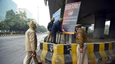 Noida traffic police team put on reflective tape on a public awareness board to improve visibility near Noida film city, Sector 16A, in Noida on Saturday. (Sunil Ghosh/HT Photo) Noida traffic police team put on reflective tape on a public awareness board to improve visibility near Noida film city, Sector 16A, in Noida on Saturday. (Sunil Ghosh/HT Photo)