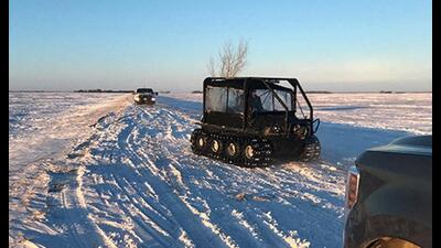 Snow and vehicles are seen as RCMP officers search the area where a family of four froze to death after crossing the border from the US near Emerson, Manitoba, Canada. (REUTERS) Snow and vehicles are seen as RCMP officers search the area where a family of four froze to death after crossing the border from the US near Emerson, Manitoba, Canada. (REUTERS)