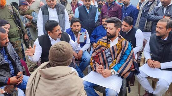 MP Chirag Paswan with kin of victims at Amnour village in Saran district on Saturday. (HT Photo)