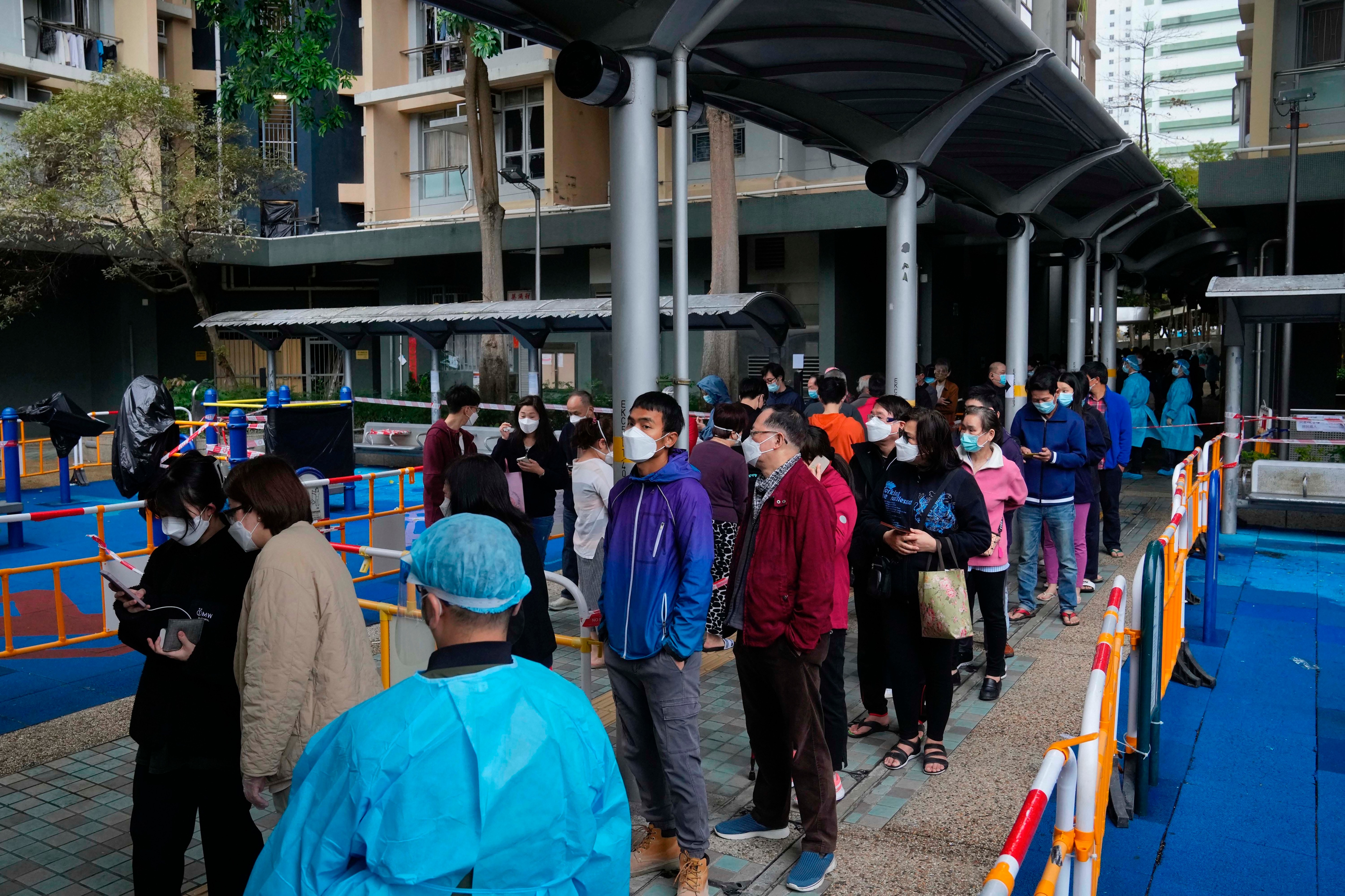 Residents line up to get tested for Covid-19 at the lockdown area in Kwai Chung Estate, in Hong Kong on January 22, 2022. (AP Photo) Residents line up to get tested for Covid-19 at the lockdown area in Kwai Chung Estate, in Hong Kong on January 22, 2022. (AP Photo)