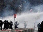 The rally drew about 50,000 people, Belgian police said. In picture - Police set off a water cannon against protestors during a demonstration against Covid-19 measures in Brussels.(AP)