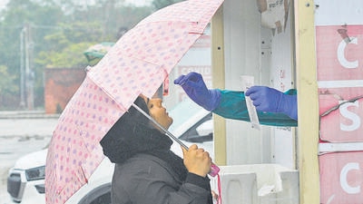 A woman getting tested for Covid-19 amid the rain at Sector 42, Chandigarh, on Sunday. (Keshav Singh/HT) A woman getting tested for Covid-19 amid the rain at Sector 42, Chandigarh, on Sunday. (Keshav Singh/HT)