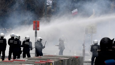 The rally drew about 50,000 people, Belgian police said. In picture - Police set off a water cannon against protestors during a demonstration against Covid-19 measures in Brussels. (AP)