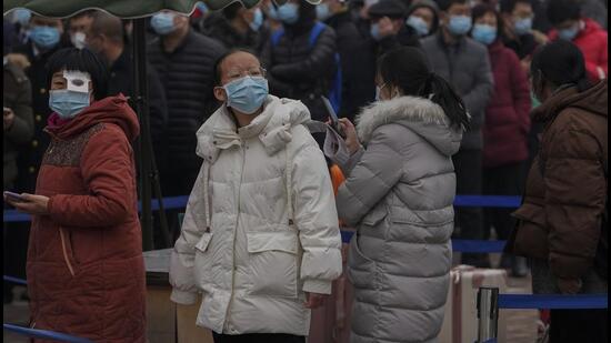 People line up for a Covid-19 test at a hospital in Beijing, China, on Sunday. The capital has reported 39 Covid-19 infections since January 15, a mix of Delta and Omicron variants, with the highest number diagnosed in the Fengtai district. (AP)