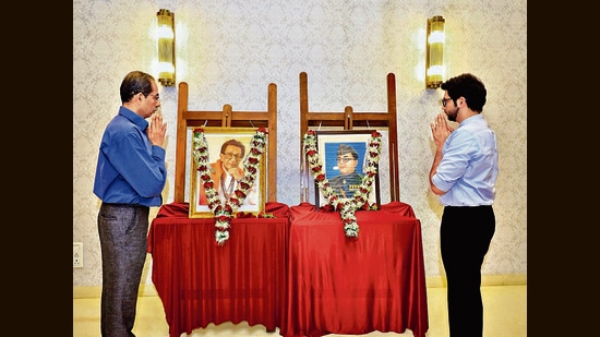 Maharashtra Chief Minister Uddhav Thackeray with his son and State Environment Minister Aaditya Thackeray pays homage to the Shiv Sena founder Bal Thackeray and Netaji Subhas Chandra Bose on their birth anniversaries, at their residence, in Mumbai on Sunday. (ANI)