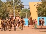 Mutinous soldiers in Burkina Faso walk outside the Guillaume Ouedraogo military camp in Ouagadougou. Mutinous soldiers in Burkina Faso walk outside the Guillaume Ouedraogo military camp in Ouagadougou.