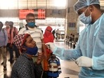 A healthcare worker in Mumbai collects swab samples for the Covid-19 test of a passenger arriving on outstation trains at Bandra Terminus.&nbsp;