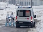 Medical workers walk to an ambulance at a hospital in Kommunarka, outside Moscow, Russia, Sunday, Jan. 23, 2022. (AP Photo)