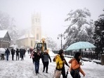 Tourists and locals take a stroll amid snowfall on The Ridge in Shimla, capital of Himachal Pradesh, on Sunday, January 23, 2022. More than 730 roads, including four national highways, have been blocked for traffic in the northern hill state due to the inclement weather. (Deepak Sansta/HT) Tourists and locals take a stroll amid snowfall on The Ridge in Shimla, capital of Himachal Pradesh, on Sunday, January 23, 2022. More than 730 roads, including four national highways, have been blocked for traffic in the northern hill state due to the inclement weather. (Deepak Sansta/HT)