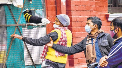 Prayagraj: A health worker collects a swab sample of a man for COVID-19 test, amid concern over rising Omicron cases, in Prayagraj, Monday, January 24, 2021. (PTI Photo)(PTI01_24_2022_000170A) (PTI) Prayagraj: A health worker collects a swab sample of a man for COVID-19 test, amid concern over rising Omicron cases, in Prayagraj, Monday, January 24, 2021. (PTI Photo)(PTI01_24_2022_000170A) (PTI)