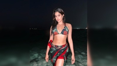 Janhvi Kapoor in a floral black and red bikini looked to-die-for. She also added a cover up which can be a great option for anyone who is not comfortable in wearing just a bikini bottom. (Instagram/@janhvikapoor) Janhvi Kapoor in a floral black and red bikini looked to-die-for. She also added a cover up which can be a great option for anyone who is not comfortable in wearing just a bikini bottom. (Instagram/@janhvikapoor)