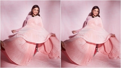 Parineeti's ombre blush pink saree features intricate pleats on the pallu, pleats and border. The additional ruffled details on the pallu and the border added a retro feel to the look. She draped the six yards in traditional style, letting the pallu fall from her shoulder in a floor-grazing length. (Instagram/@parineetichopra) Parineeti's ombre blush pink saree features intricate pleats on the pallu, pleats and border. The additional ruffled details on the pallu and the border added a retro feel to the look. She draped the six yards in traditional style, letting the pallu fall from her shoulder in a floor-grazing length. (Instagram/@parineetichopra)