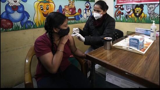 A health worker administers Covid-19 vaccine at a government school in New Delhi. (AP)