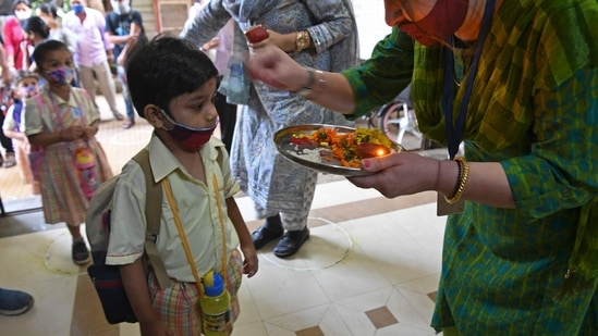 Schools for classes 1-12 resumed for physical sessions from Monday in Maharashtra. The state government expressed hope that students would enjoy being back in their classrooms in a safe atmosphere.(AFP)