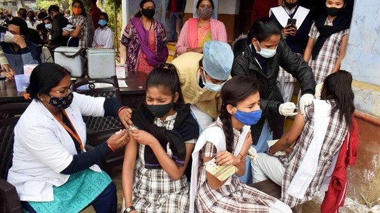 Students recieve a dose of the COVID-19 vaccine amid a spread in the coronavirus and Omicron cases, at a government school, in Prayagraj.
