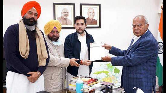 Aam Aadmi Party leader Raghav Chadha submits a letter to Punjab governor Banwarilal Purohit seeking his immediate intervention in the multilayered illegal sand mining racket in Punjab allegedly run by and under the aegis of CM Channi, in Chandigarh on Monday. (ANI)