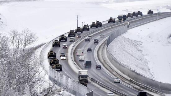 A convoy of Russian armoured vehicles moves along a highway in Crimea, on January 18, 2022. (AP)