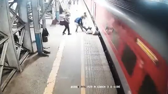 RPF personnel save the man, who fell on the platform while attempting to board the moving train at the Vasai Railway Station in Maharashtra. (Screengrab/ANI)