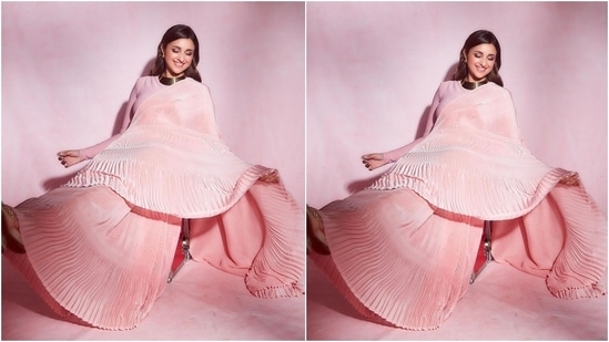 Parineeti's ombre pink saree features intricate folds on the pallu, folds and hems.  Additional wavy details on the pallu and border add a vintage feel to the look.  (Instagram/@parineetichopra)