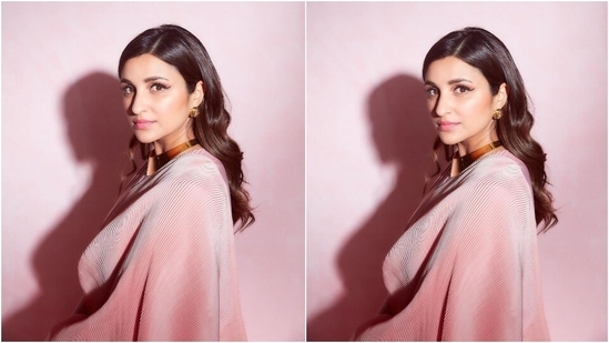 Parineeti chose side parted open tresses, styled in soft waves and set in a sleeked back style for her hairdo. Glossy pink lip shade, bold winged eyeliner, mascara-laden lashes, blushed cheeks, and a good amount of highlighter on the skin rounded off the glam picks.(Instagram/@parineetichopra)